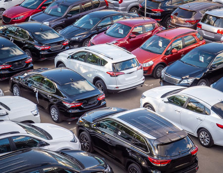 Car dealership lot filled with new and used vehicles, ready for expedited car transport services across the U.S.
